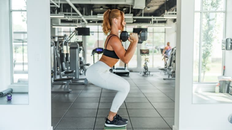 Premium Photo  Fit strong and active young athlete stretching legs for  warmup performance and to prepare for exercise workout and training against  a colorful studio background healthy toned and beautiful woman